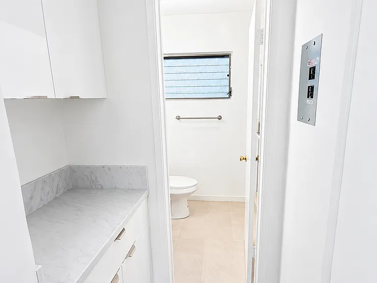 Additional built-in cabinet storage conveniently located near the bathroom.