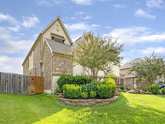 Beautifully landscaped with extra trees to give fullness to the yard. Beautiful curb appeal.