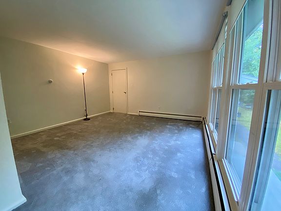 Another view of the living room. Door leads out to the common area hallway.