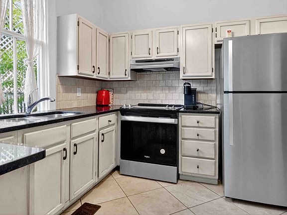 Spacious Gourmet Kitchen with Updated Appliances and Granite Countertops.