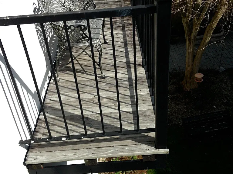 balcony off living and dining room over looks fountain landscaped courtyard with common seating/grill
