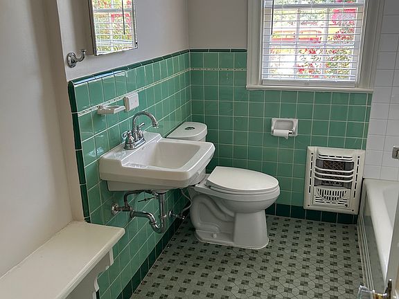 Retro tiles have been thoughtfully restored, while the shower and surrounding tiles have been completely updated!