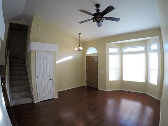 Living Room and Stairs leading to three bedrooms/two bathrooms.