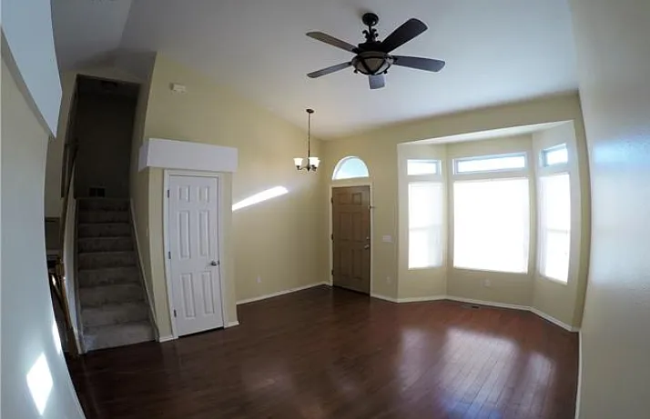 Living Room and Stairs leading to three bedrooms/two bathrooms. - 8011 Watervalley Rd