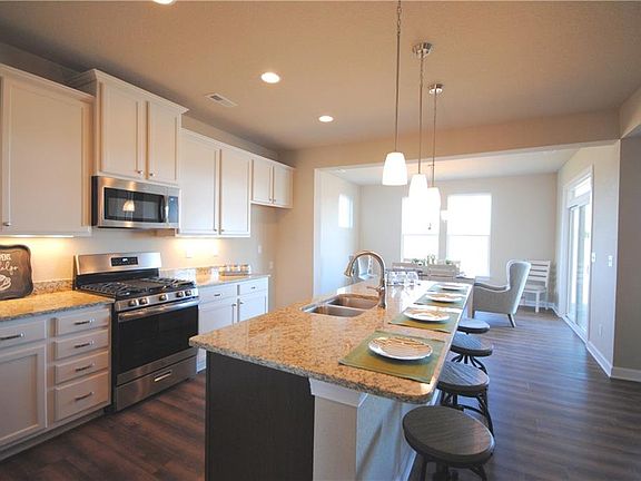 Gas range, under cabinet lighting, large one level island with overhang.