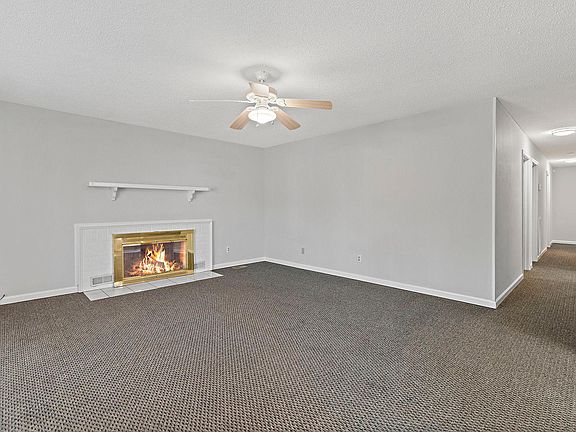 Living room: efficient ventless gas fireplace in back. Ceiling light with fan. Bay window facing front yard to left.s