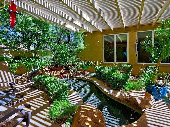 Courtyard with a stream flowing thru from a waterfall. There is access from the front entrance, the 