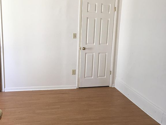 Bedroom with dual closets and new wood look flooring