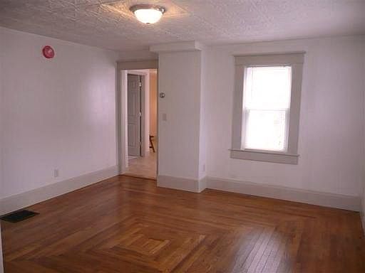 Newly refinished hardwood in the Living Room and a tiled Powder Room by the Kitchen.