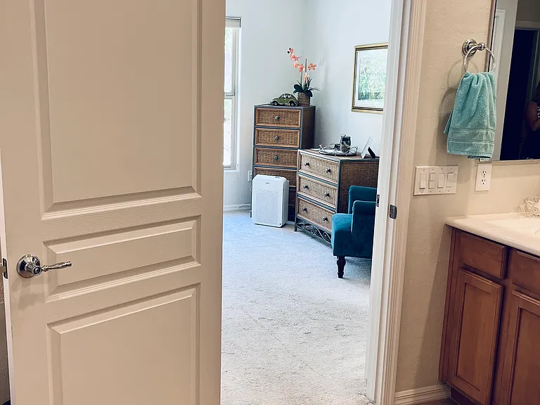 View from primary en-suite bathroom into primary bedroom.