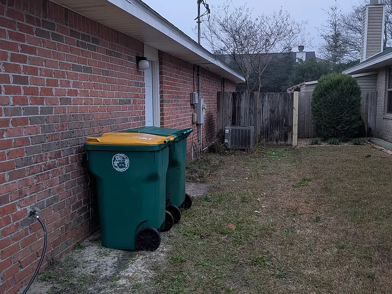 Side yard. Door is to garage.