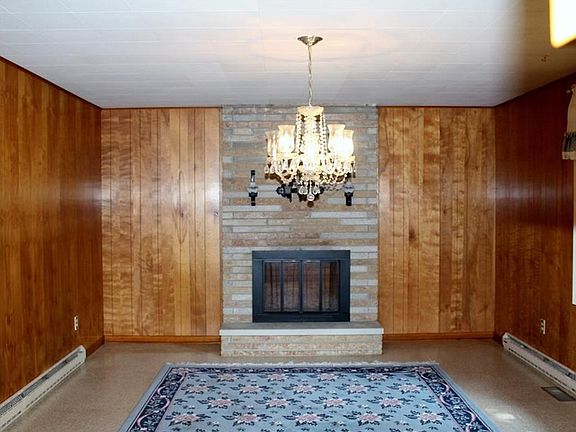 Family room with stone fireplace or could use as dining room.