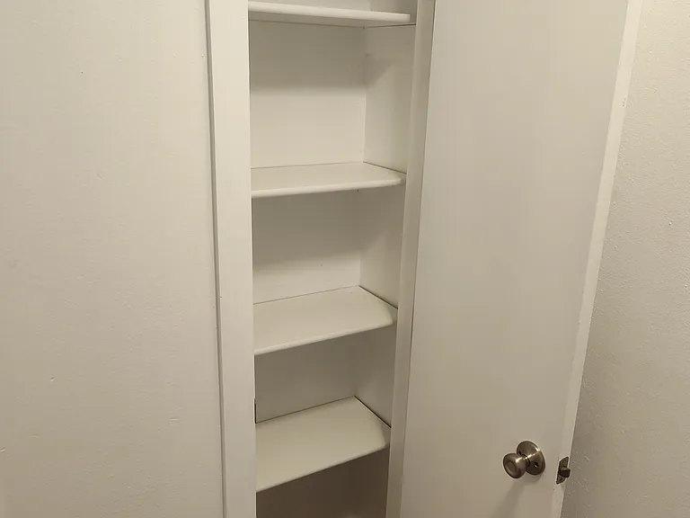 Top of the stairs looking at the linen closet open.