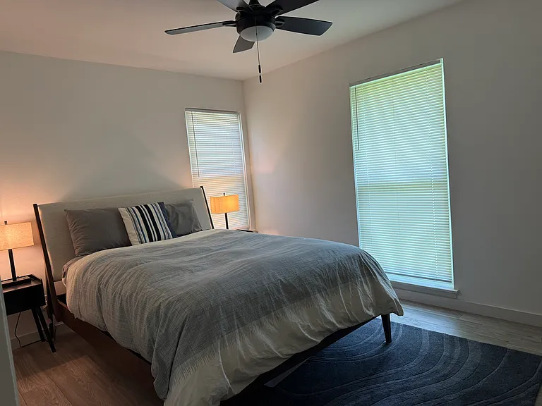 Second bedroom with queen bed and dresser.