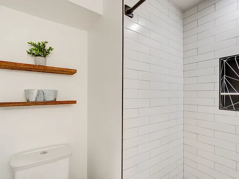 Warm wood wall shelving adds visual texture while providing stylish and functional storage.