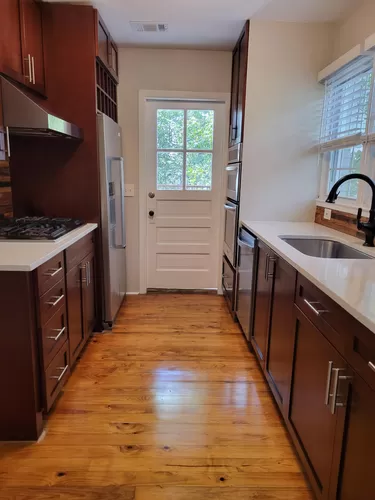 Kitchen with updated stainless steel appliances and quartz countertops. - 498 Trabert Ave NW