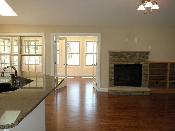 Open floor plan with hardwood & cathedral ceiling