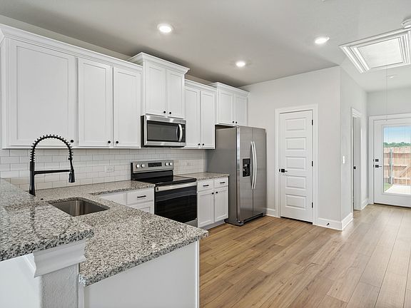 The kitchen has sprawling granite countertops.