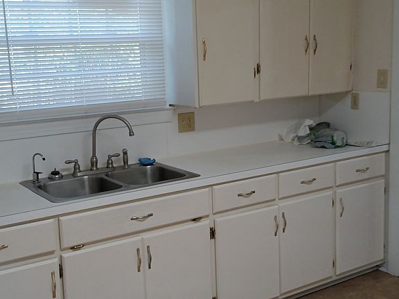 Lots of kitchen cabinets, new easy-cleaning stainless steel sinks, kitchen faucet, and purified water dispensing faucet. It is bottled water without the bottles.
