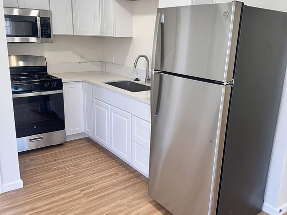 Kitchen, new cabinets, applicances, countertops, and sink.