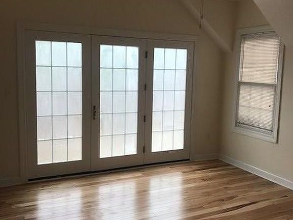 Dining room with French doors and hardwood floors.
