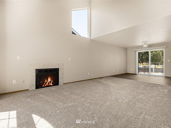 The foyer opens into the grand and spacious vaulted living room. 