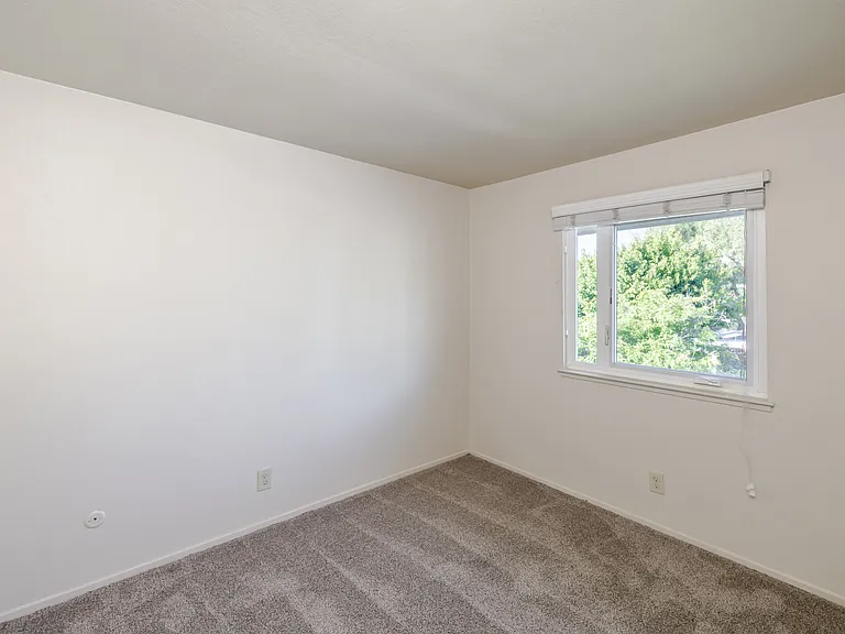 Bright and inviting, Bedroom B offers a tranquil view and natural light.