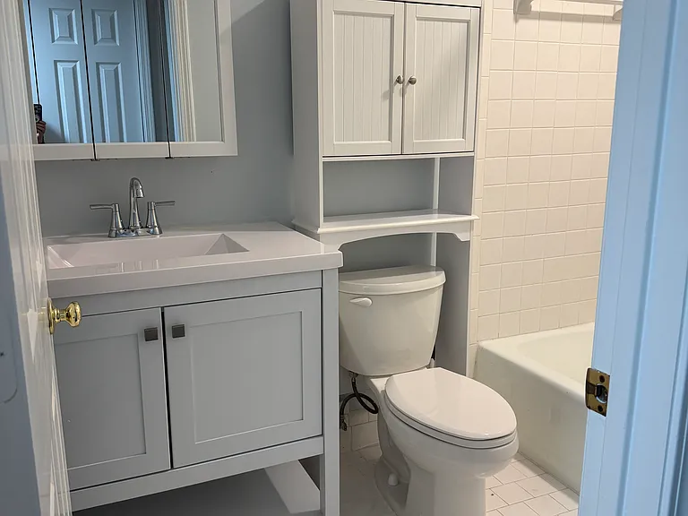 Updated guest Bathroom with new vanity, medicine cabinet, and over the toilet storage rack.