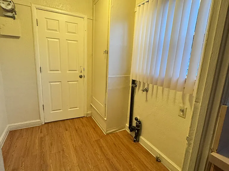 Laundry area, with hookups available for washer / dryer: and door to back entrance / parking area