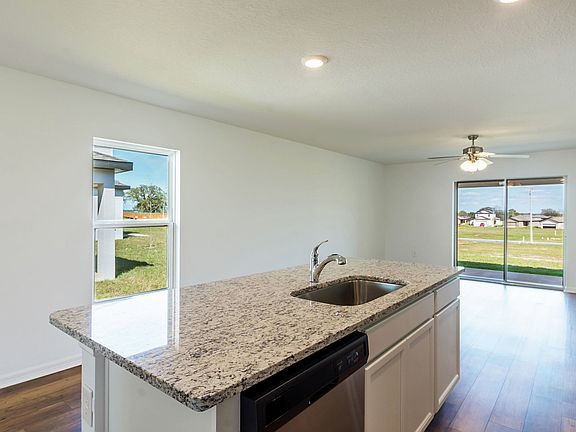 The kitchen island looks out over the entertainment space