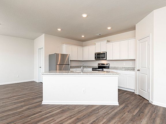 The kitchen is chef-ready with stainless steel appliances