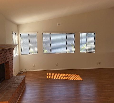 Large Living Room with fireplace that opens to Dining Room