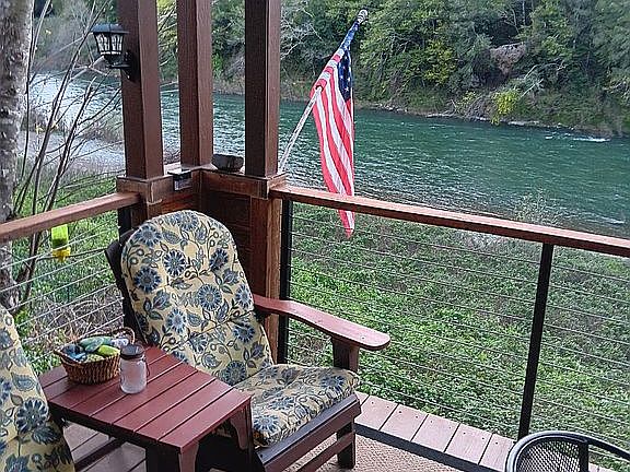 Covered deck w/river view.