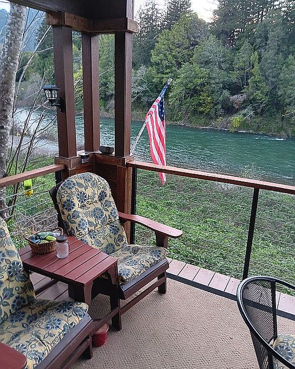 Covered deck w/river view.