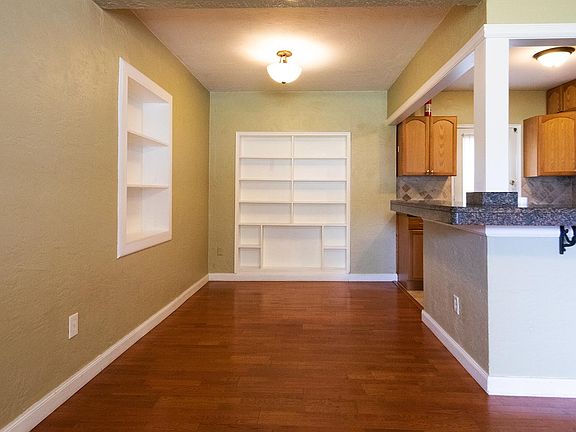 The dining area has two walls of built-in shelves.