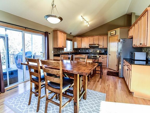 Kitchen has track lighting, new handles, and faucet.