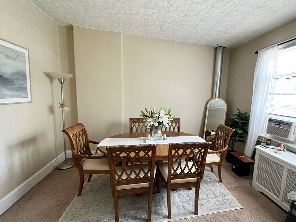 Downstairs with furniture next to the
 spiral staircase.