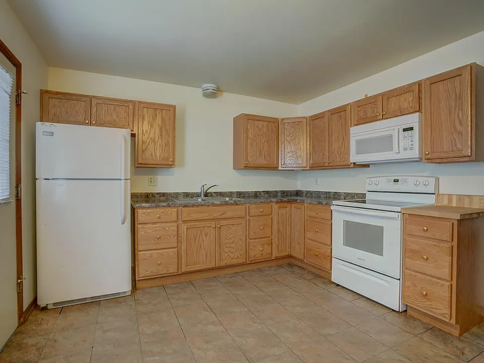 Electric range, microwave, and garbage disposal included
