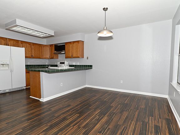 Dining room and kitchen. Appliances have been updated to stainless steel since this photo.