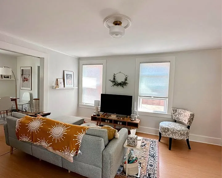 View of living room as you walk into apartment. Dining room and bedrooms to the left and the kitchen, pantry, bathroom, laundry and rear exit to the right.