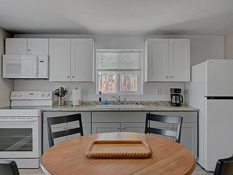 Bright open-concept living and kitchen area with modern finishes and comfortable dining space