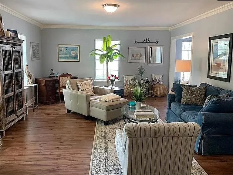 Downstairs large, formal living room. The office is shown to the right off the living room.