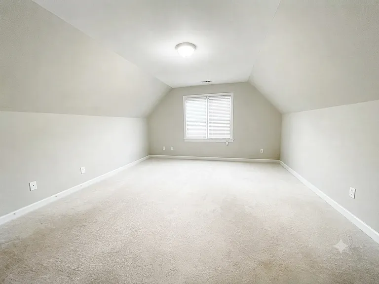 Large upstairs bonus room with a door for added privacy_ideal as a home office, gym, playroom, entertainment room, media room, guest bedroom, or flexible living space to suit your needs.