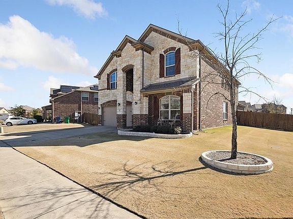French country inspired facade with a garage