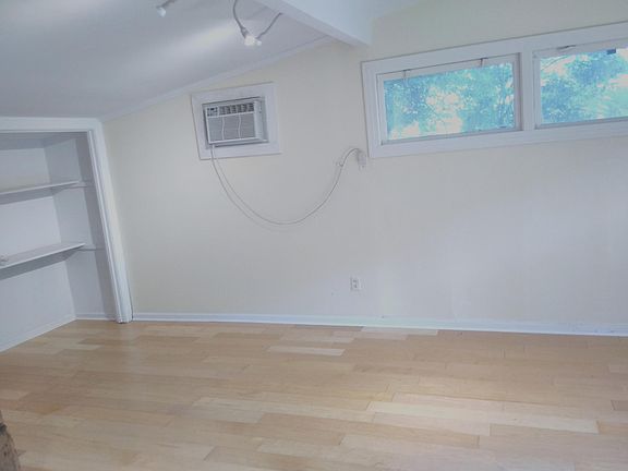 Living space w/ maple floors and closet