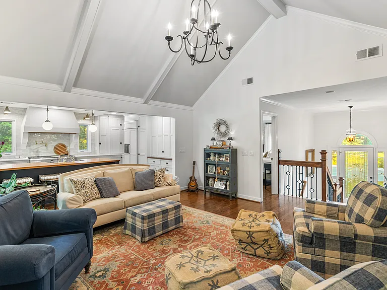 Spacious and bright living room at the top of the foyer stairs. Enjoy plenty of seating, a Smart TV, and lots of natural light.
