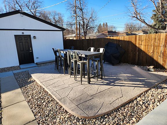 additional patio with bar height tables + chairs, charcoal grill