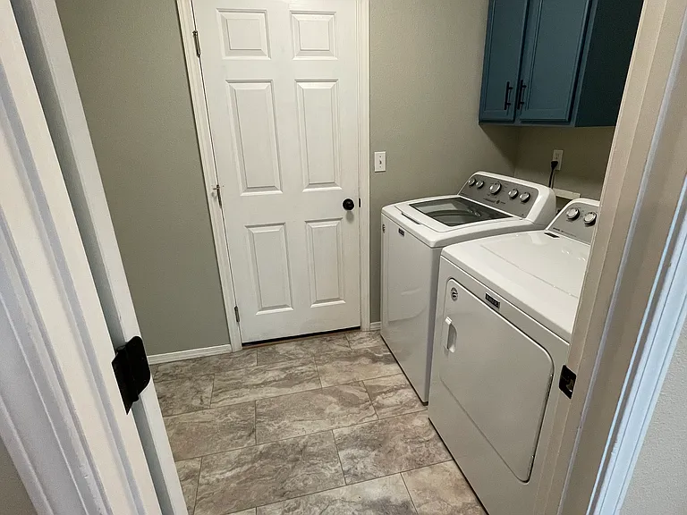 Laundry with entrance to two car garage