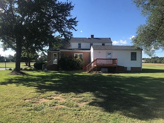 Back of two story house, very large shade trees and ample yard.