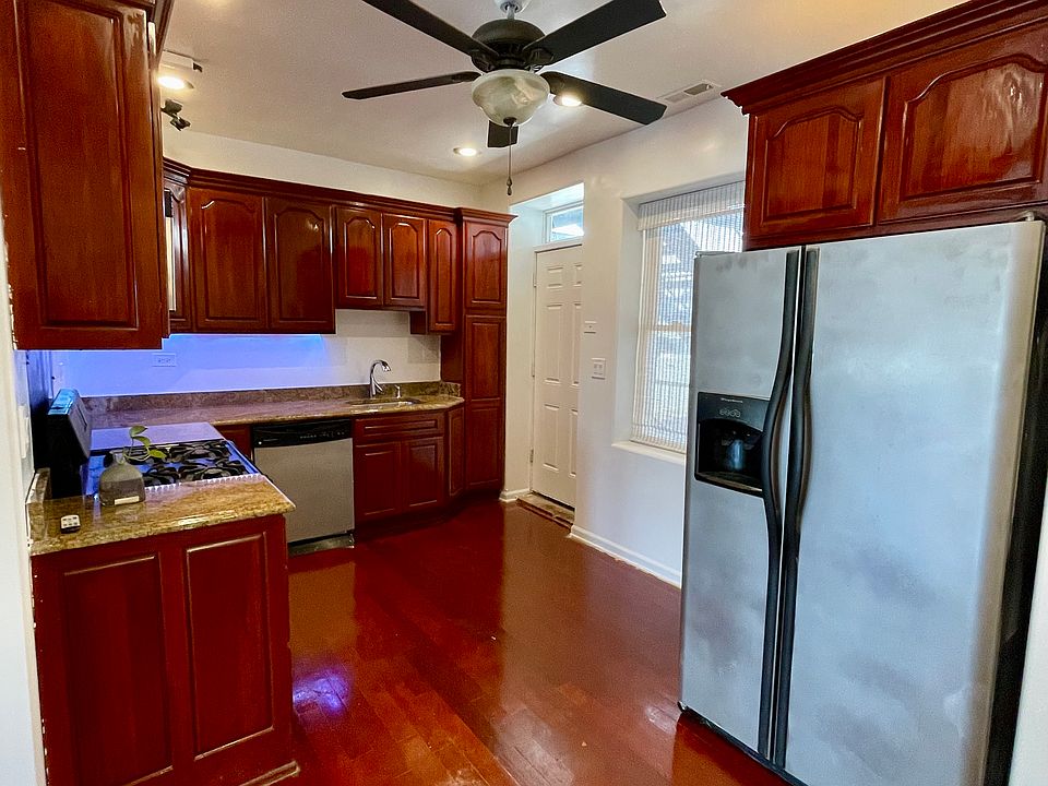 Kitchen has lots of cabinets and stainless appliances.